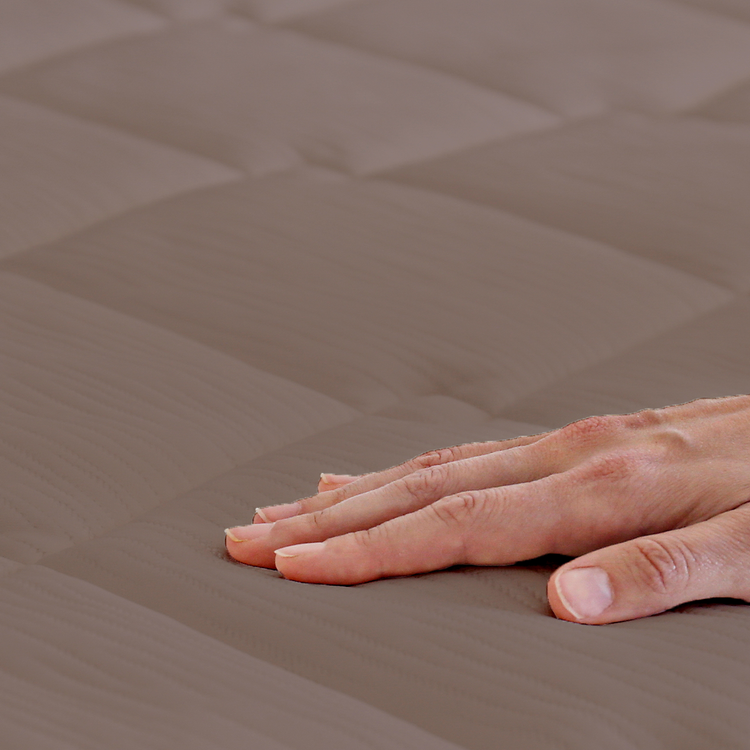 Hand resting on a textured brown surface