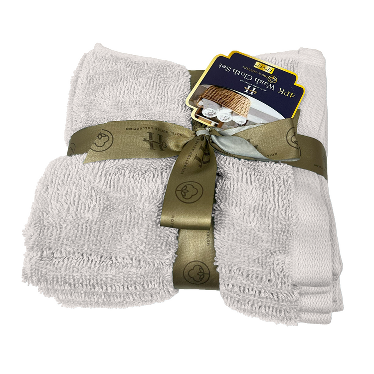 Set of white towels with a gold ribbon and tag on a white background