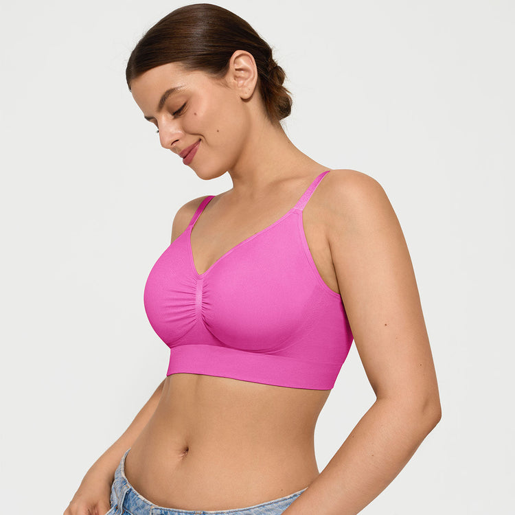 Woman wearing a pink sports bra on a plain background