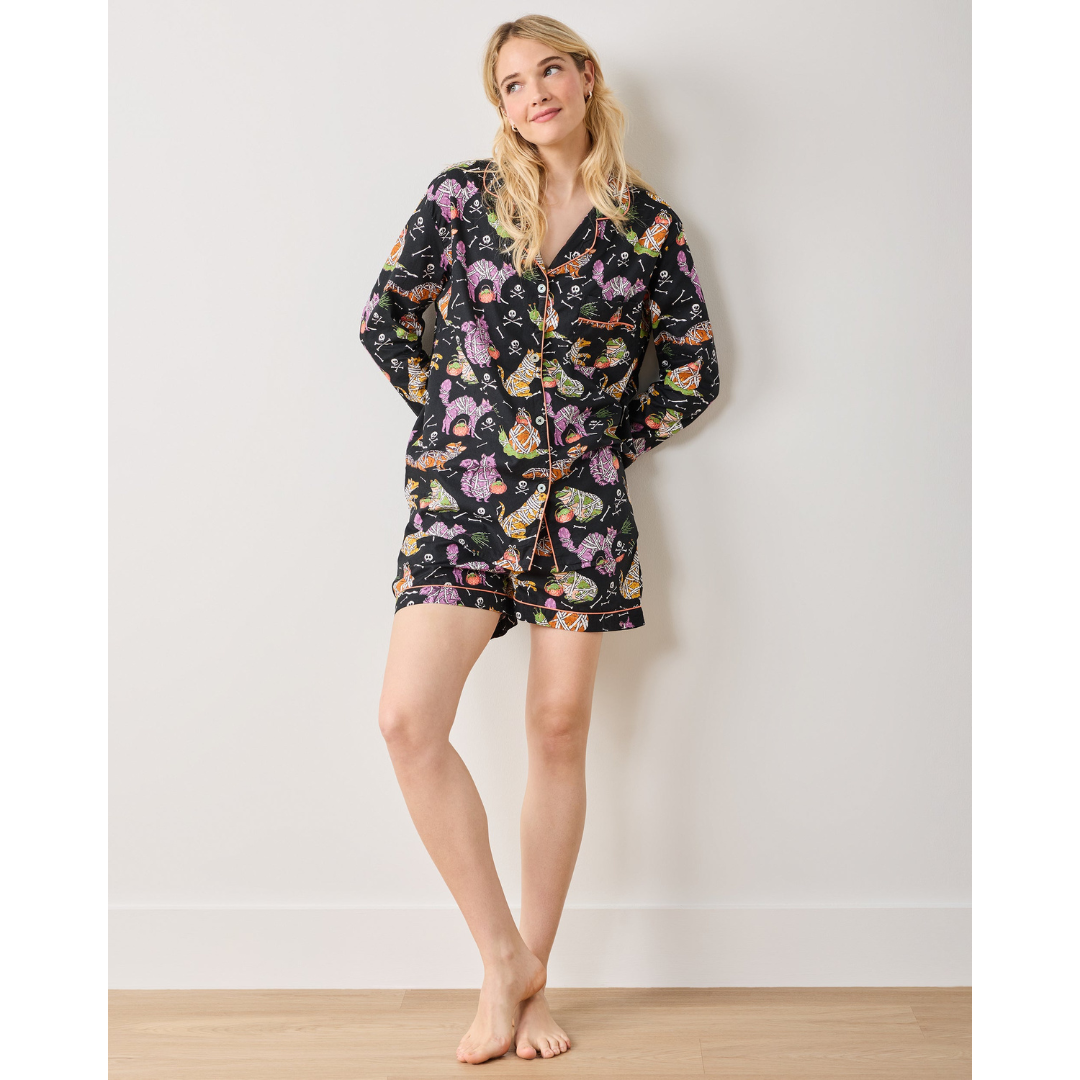 Woman wearing a floral pajama set against a plain background