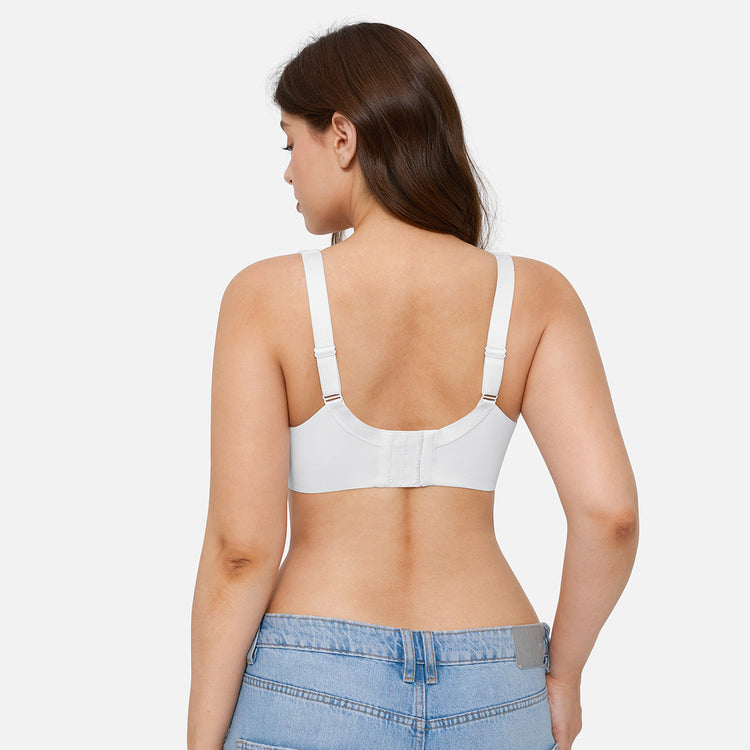 A woman shown from the back wearing a white underwire bra with adjustable shoulder straps and a center gore closure, paired with light blue jeans against a light gray studio background.