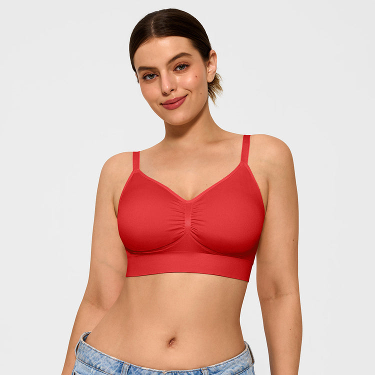 Woman wearing a red bralette against a plain background