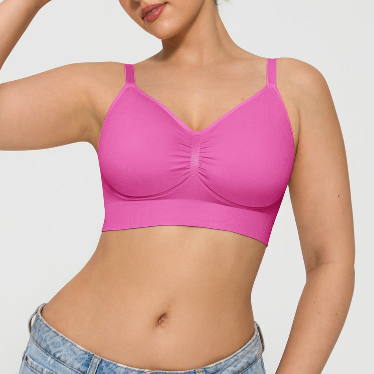 Person wearing a pink bralette on a plain background