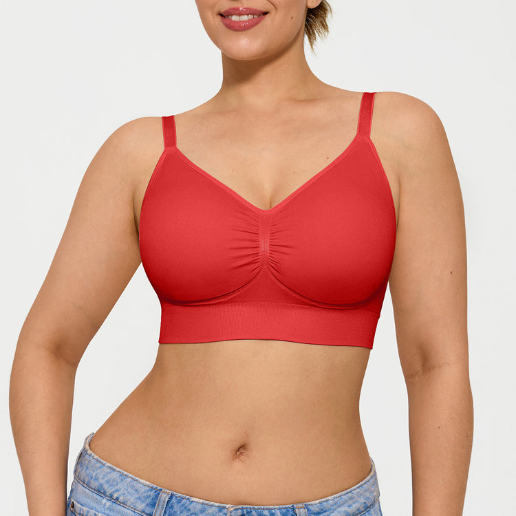 Woman wearing a red bralette against a plain background