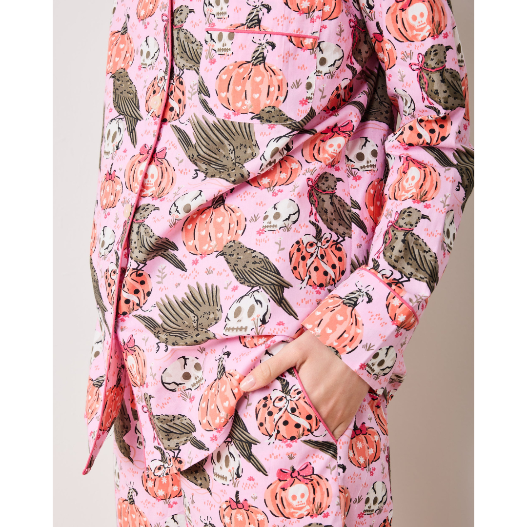 Pink robe with Halloween-themed pattern featuring pumpkins, ghosts, and cats.