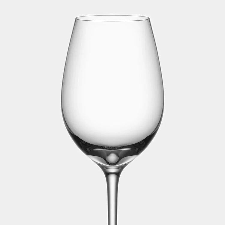 Clear wine glass on a light gray background