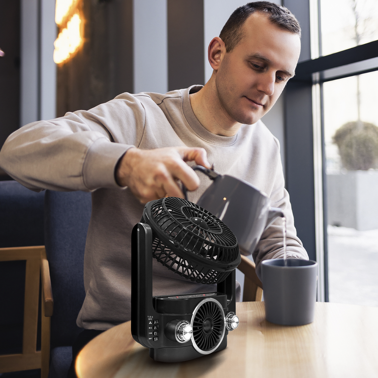 Man drinking tea with the fan in the table