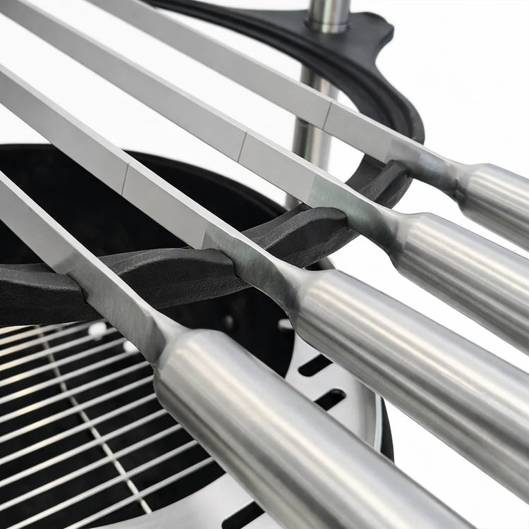 Close-up of a car's three-barreled exhaust system with metallic finish.