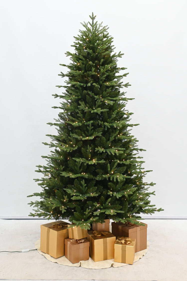Decorative Christmas tree with gold presents on a white background