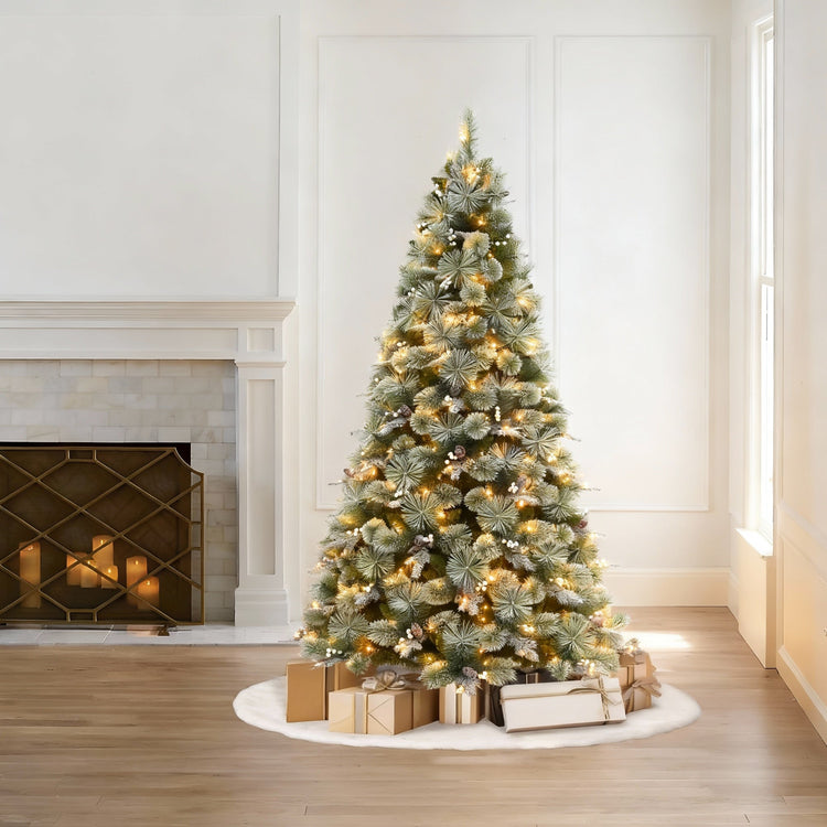 Decorated Christmas tree with lights and presents in a living room with a fireplace.