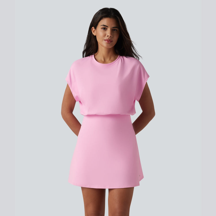 Woman wearing a pink dress against a plain background