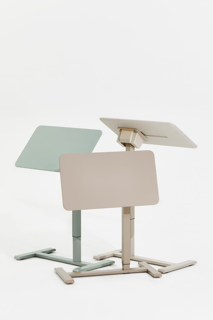 Two adjustable standing desks in pastel colors on a white background