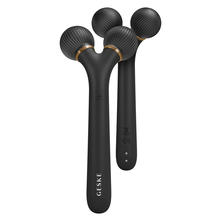 Black massage tool with spherical heads on a white background