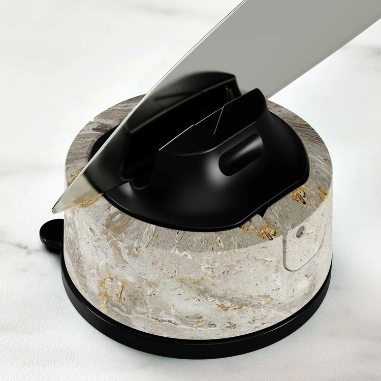 Knife sharpener with a knife on a marble base