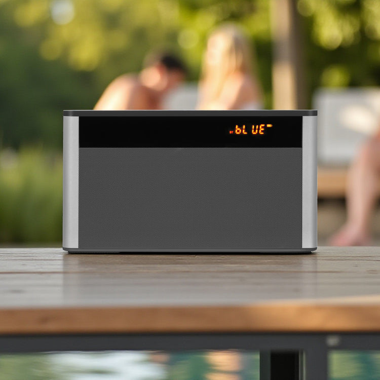 Black electronic device with digital display on a wooden surface outdoors