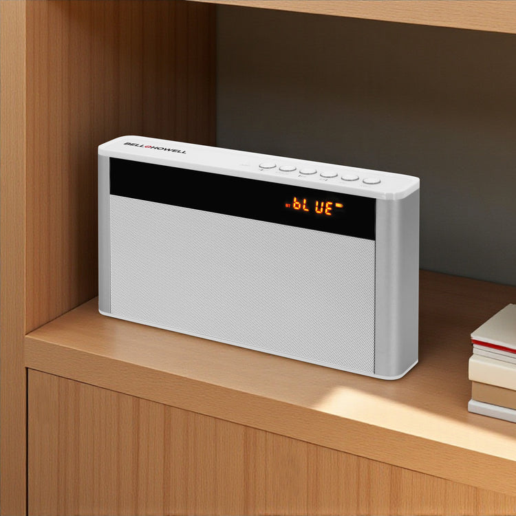 White electronic device with digital display on a wooden shelf