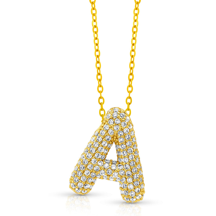 A gold-plated necklace with a large initial pendant adorned with cubic zirconia stones.
