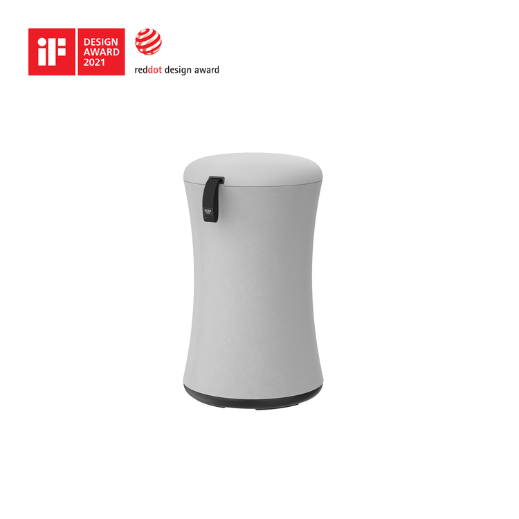 Gray cylindrical product with a black handle on a white background, featuring design awards logos.