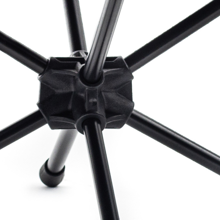 Close-up of a black metal chair leg with a white background