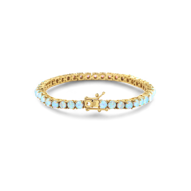 Gold bracelet with light blue stones on a white background