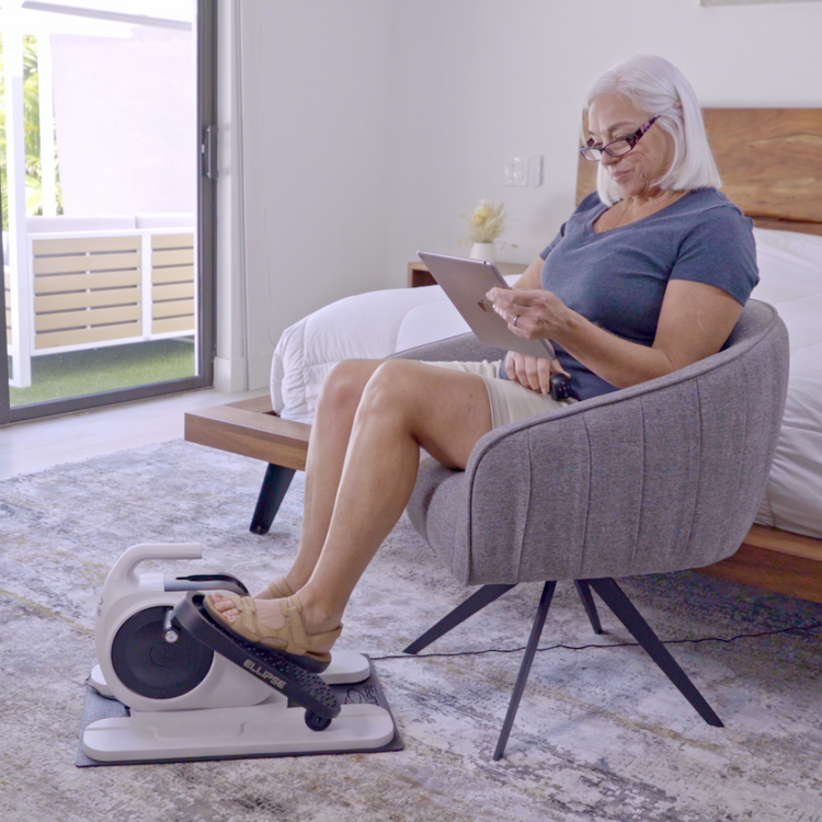 Woman using a pedal exerciser in a home setting