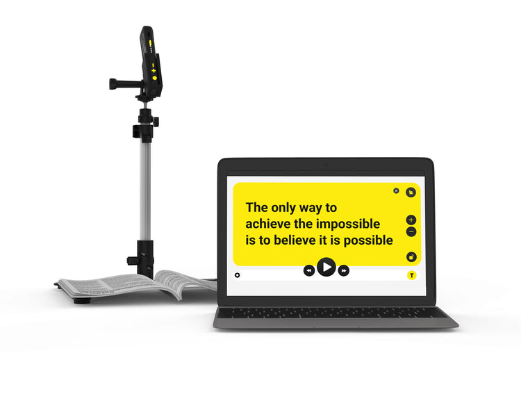 Laptop with motivational quote on screen next to a microphone stand on a white background