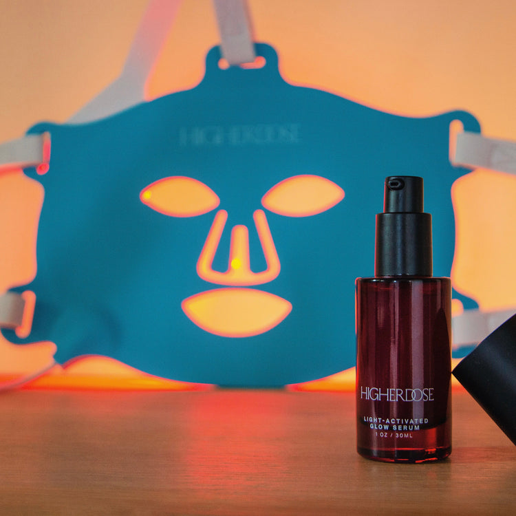 Bottle of Higher Idee skincare product with a blue mask in the background