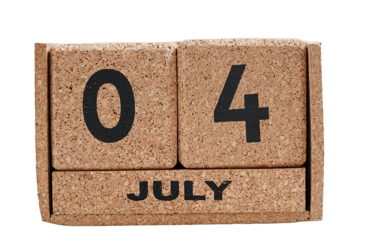 Cork calendar block displaying '07 4 JULY' on a white background