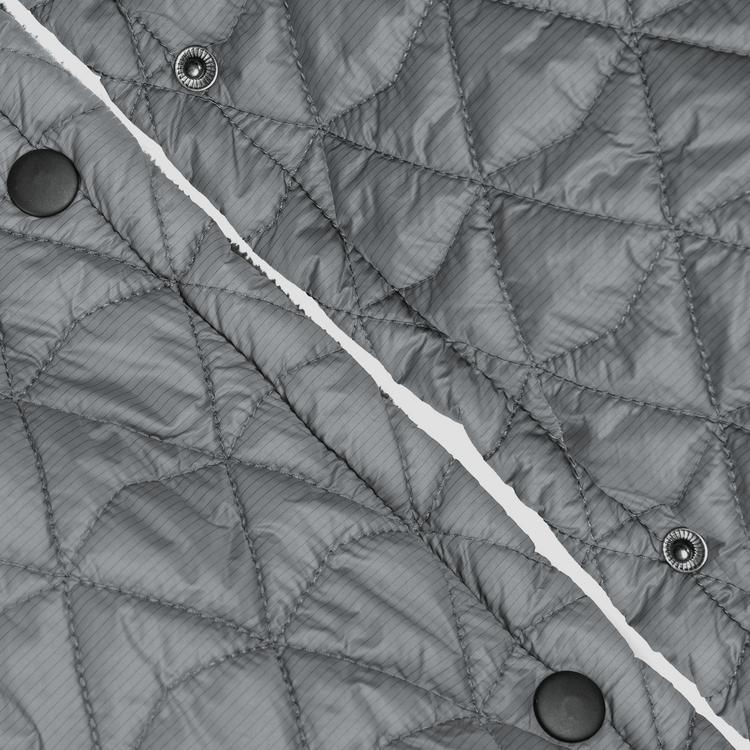 Close-up of a quilted gray jacket with button details