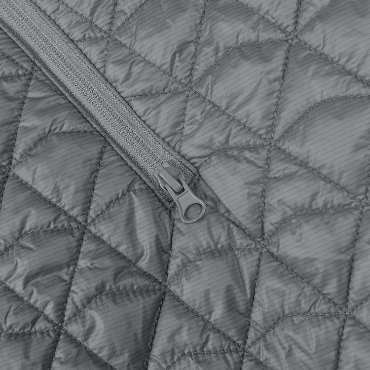 Close-up of a gray quilted jacket with a zipper