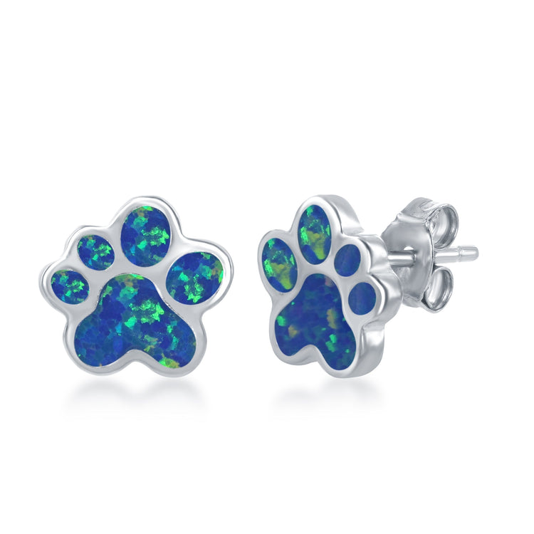 A pair of sterling silver stud earrings with blue inlay opal in the shape of a paw print.