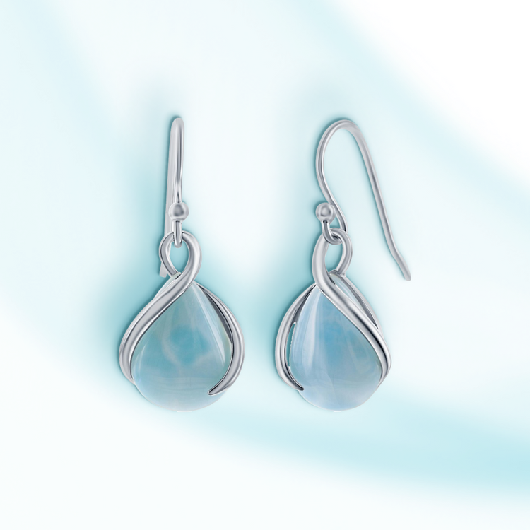 A pair of sterling silver earrings with pear-shaped Larimar stones, displayed against a light blue background.