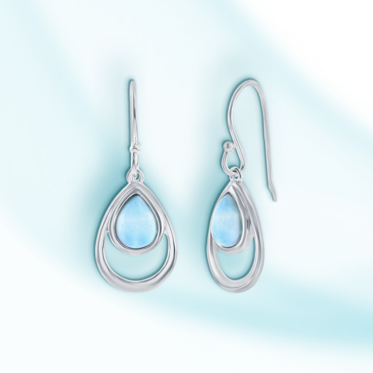Silver teardrop earrings on a light blue gradient background
