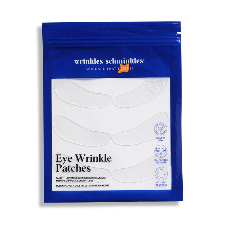 A blue packaging pouch with the brand 'Wrinkles Schminkles' written on it, containing eye wrinkle patches designed to be applied under the eyes for smoothing and hydrating the skin.