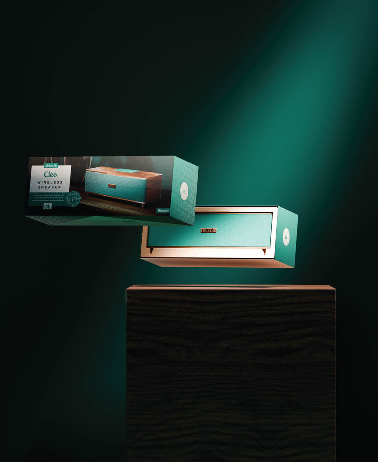 Teal jewelry box with gold accents on a dark background