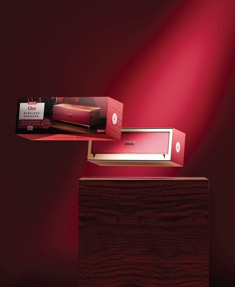 Red electronic device on a stand with packaging in the background