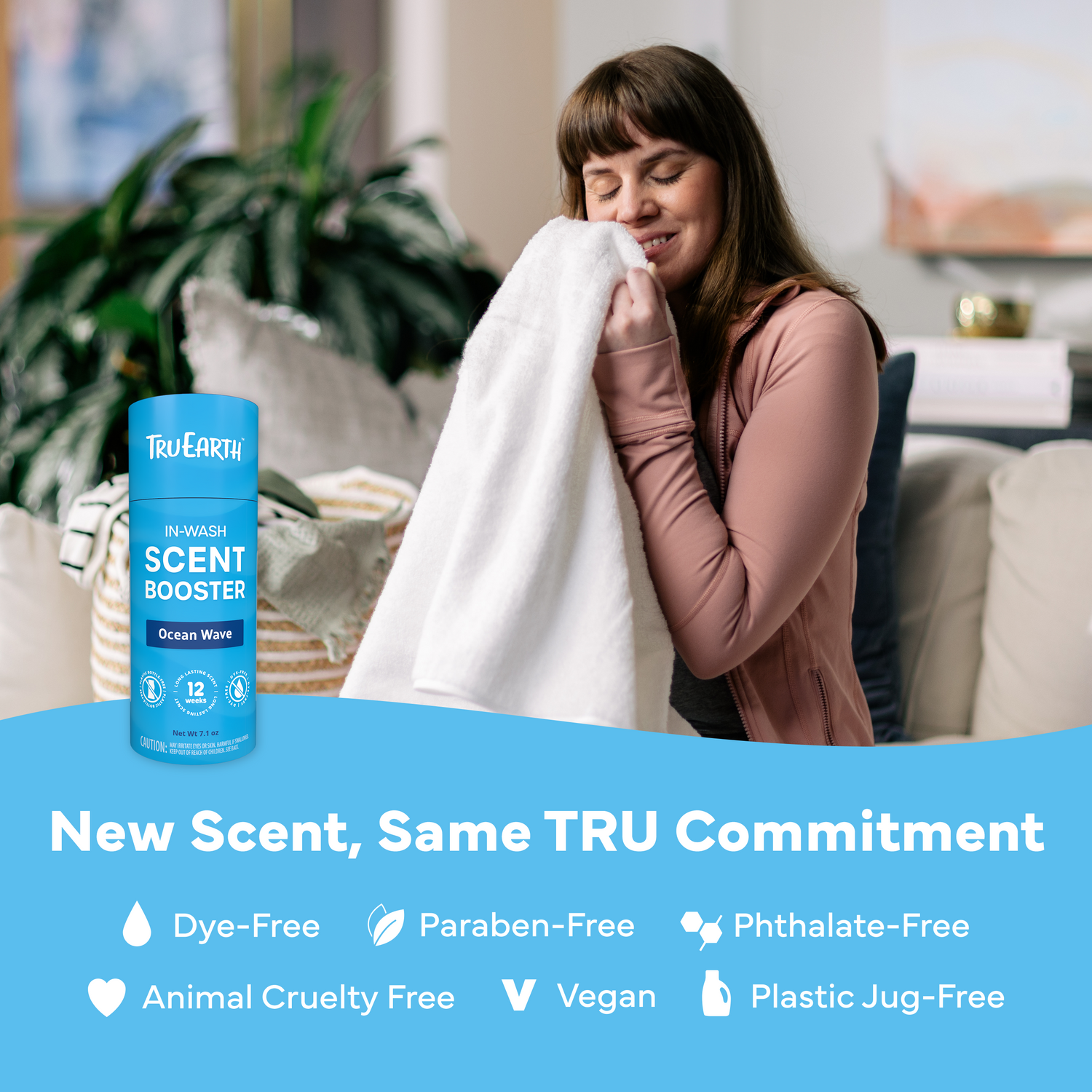 Woman holding a towel next to a bottle of Tru Earth In-Wash Scent Booster with product features listed below.