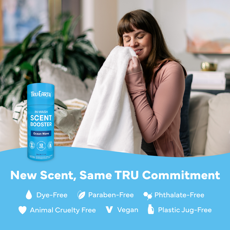 Woman holding a towel next to a bottle of Tru Earth In-Wash Scent Booster with product features listed below.