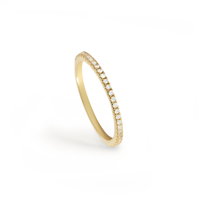 Gold ring with small diamonds on a white background