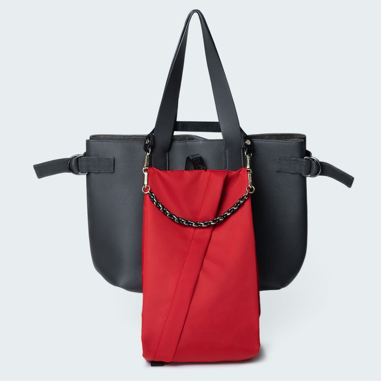 Black and red handbag with a chain detail on a light gray background