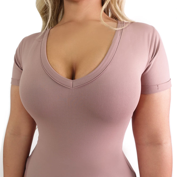 Pink bodysuit worn by a person on a white background