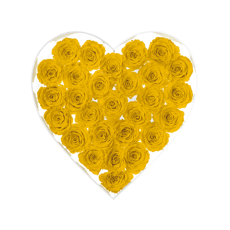 Heart-shaped arrangement of yellow roses in a clear heart-shaped container on a white background