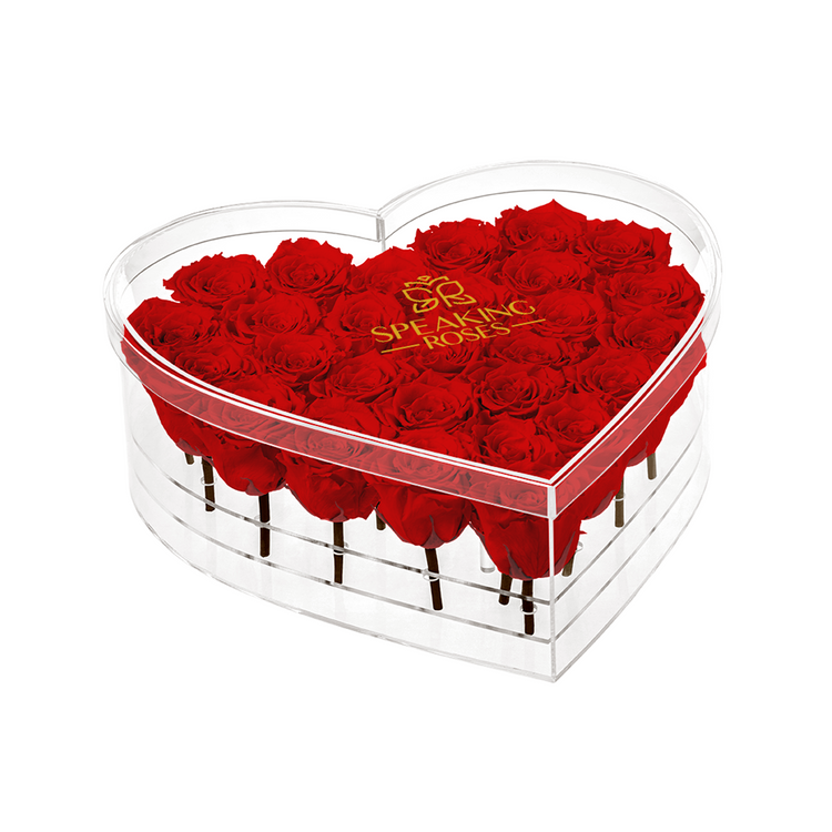 Heart-shaped box of red roses with 'Speaking Roses' branding on a white background