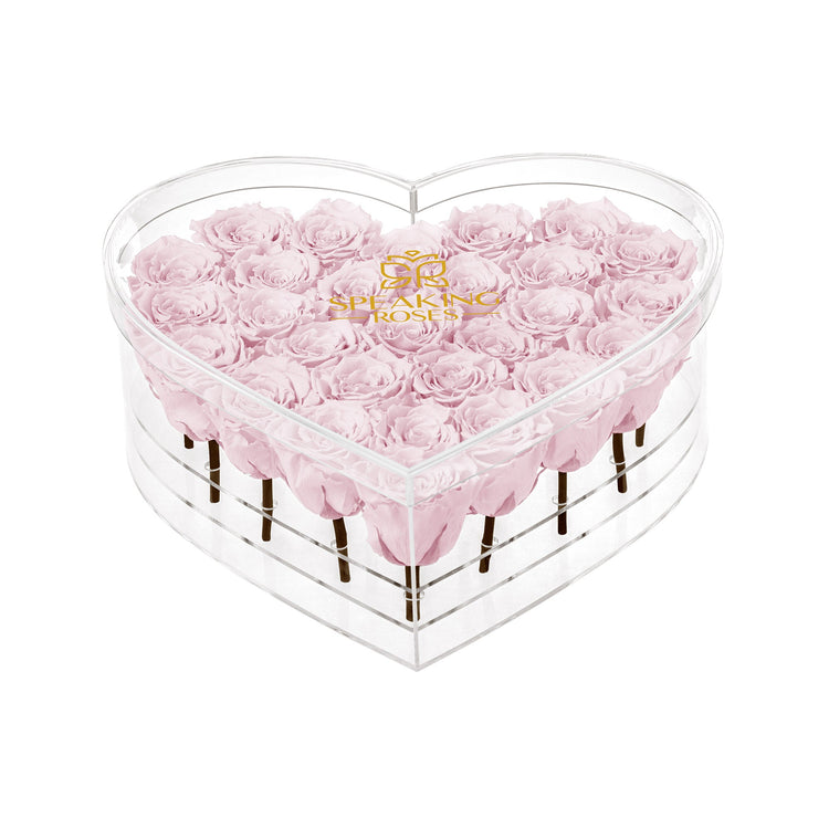 Heart-shaped box with pink roses and 'Bouqs' logo on a white background
