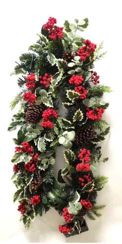 Decorative wreath with greenery, red berries, and pinecones on a white background