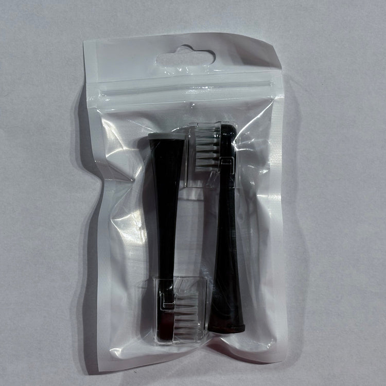 Clear plastic packaging with a black and clear hairbrush on a gray background