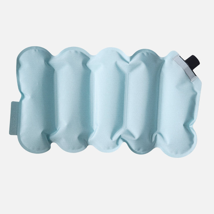 Inflatable light blue cushion with a valve on a white background