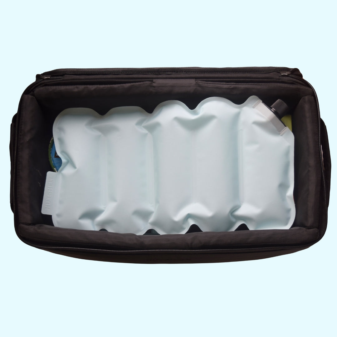 Black travel bag with white ice packs on a light blue background