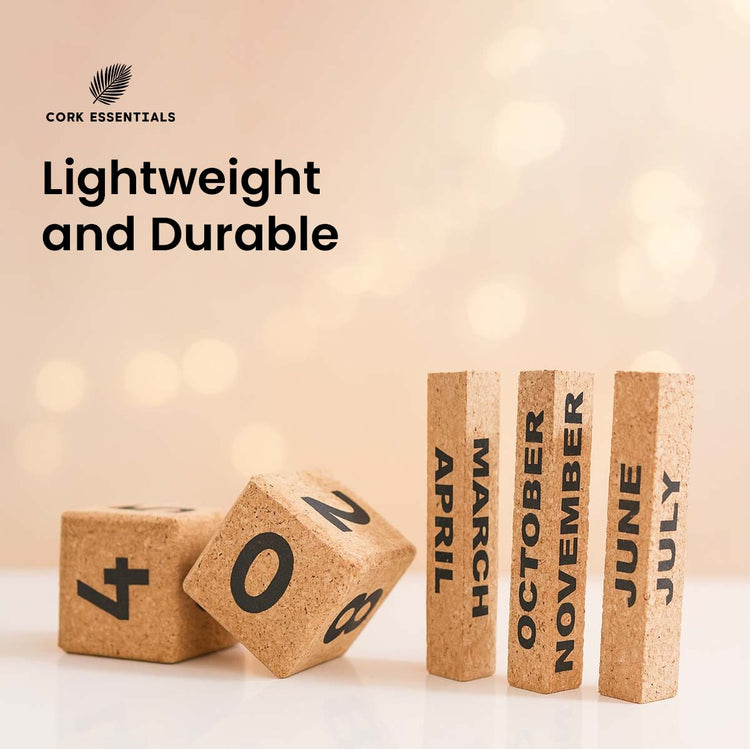 Cork blocks with months printed on them and cork dice on a light background, featuring Cork Essentials branding.