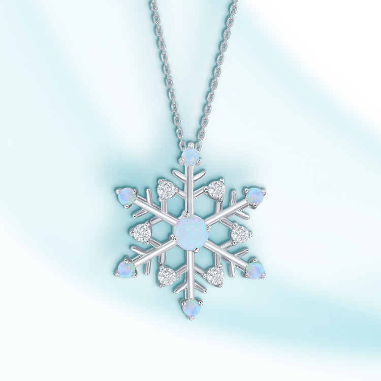 Snowflake-shaped necklace with gemstones on a light blue background
